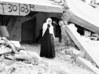 Woman living in debris of her destroyed house in east Khan Younis. February 2015. Photo by OCHA