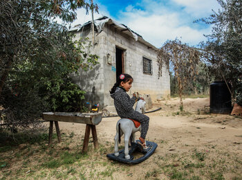 Four-year-old Leen Abu Hajras playing in front of her home in Khan Younis, the Gaza Strip, following her recovery from malnutrition. Photo by Mohammed Al Reefi for the Catholic Relief Services.