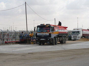 A Palestinian truck at the Israeli Kerem Shalom crossing, carrying fuel purchased from Israeli vendors to run the Gaza Power Plant; in November, electricity provision in Gaza lasted 10-16 hours per day, on average. Photo by OCHA