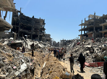 People in a destroyed residential area of Jabalya. Photo by OCHA, 19 June 2024 