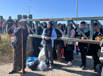 Palestinian farmers in Jerusalem governorate waiting at Beit Izja agricultural gate to access their agricultural lands and harvest their olive trees that have been isolated by the West Bank Separation Barrier.  Photo by OCHA 