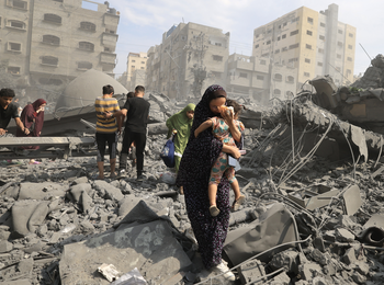 Palestinians in Gaza city inspect the damage following an Israeli airstrike, 9 October 2023, photo by Mahmud HAMS / AFP