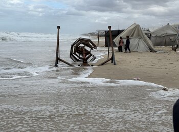 Displaced Palestinians in a makeshift site of Al Mawasi, in Khan Younis, where tents were flooded by rain and high tides overnight on 25 November. Photo by OCHA