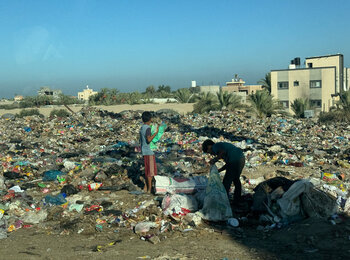 Children in Gaza searching through scattered waste. Photo by OHCHR/Olga Cherevko