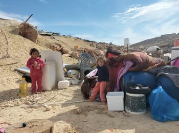 Children amid properties extracted from a Palestinian house set to be demolished by Israeli forces in Tell al Khashaba, Nablus. Photo by OCHA, 10 December 2024 