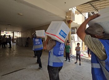 UNRWA Team providing assistance to displaced families in Al- Tabi’een school in Gaza city. Photo: UNRWA 