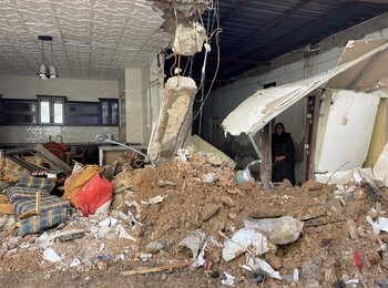 An elderly woman stands amid the ruins of her home, destroyed during a 46-hour Israeli operation in the Jenin refugee camp that began on 18 November 2024. Photo: OCHA. 