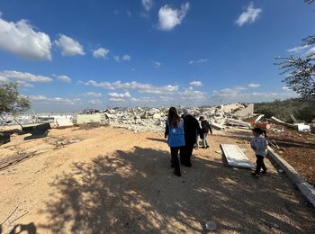 A Palestinian family from Deir Ballut, Salfit, shows an aid worker the three agricultural structures demolished by the Israeli Civil Administration, 17 December 2024. Photo by OCHA