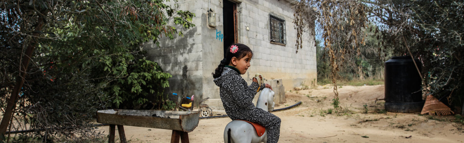 Four-year-old Leen Abu Hajras playing in front of her home in Khan Younis, the Gaza Strip, following her recovery from malnutrition. Photo by Mohammed Al Reefi for the Catholic Relief Services.