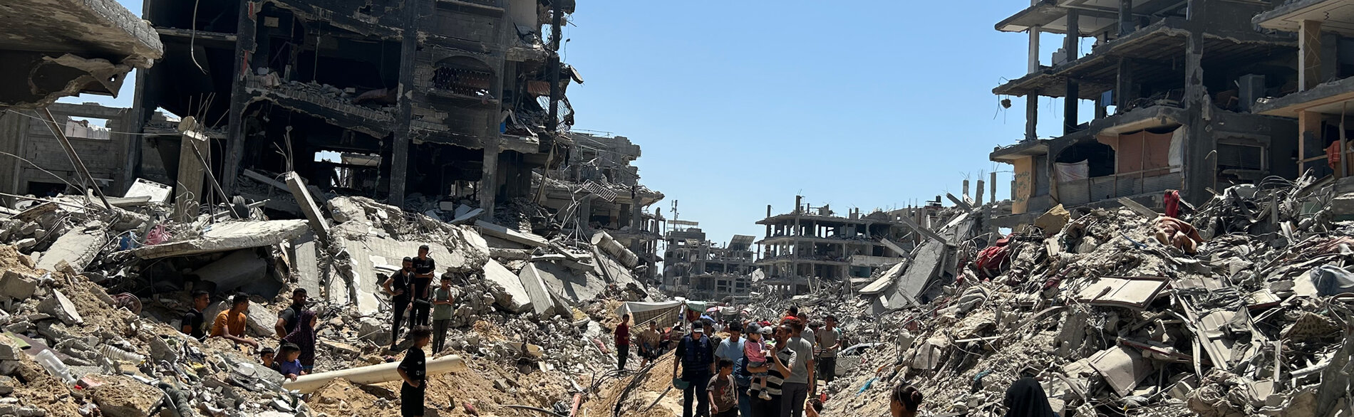 People in a destroyed residential area of Jabalya. Photo by OCHA, 19 June 2024 