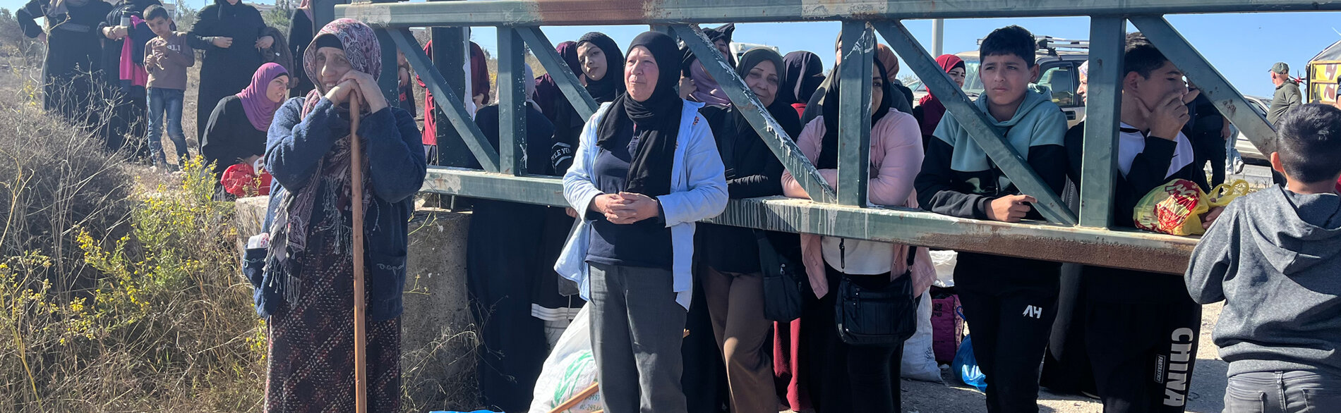 Palestinian farmers in Jerusalem governorate waiting at Beit Izja agricultural gate to access their agricultural lands and harvest their olive trees that have been isolated by the West Bank Separation Barrier.  Photo by OCHA 