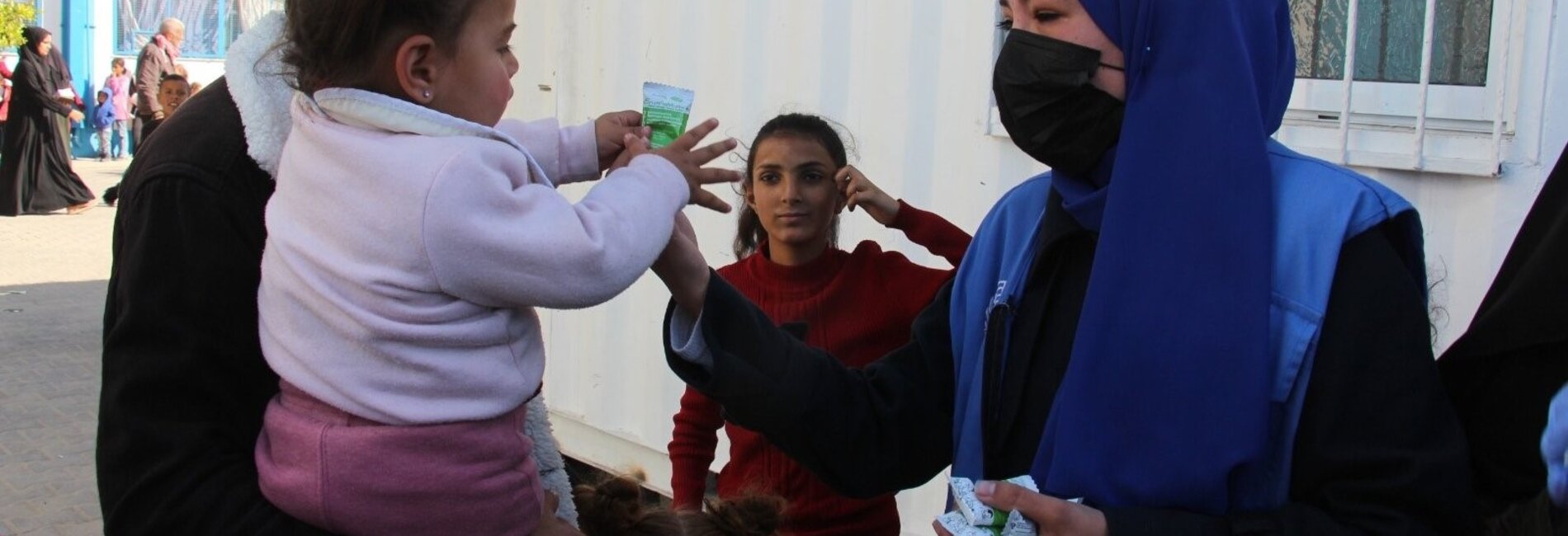 A humanitarian worker distributing vitamin supplies and nutrientsin Khan Younis. Photo by UNRWA 