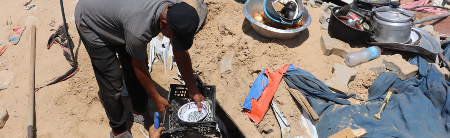 A Palestinian family trying to dig out what remains of their possessions after their house was destroyed in Bani Suheila, Khan Younis. Photo Themba Linden OCHA 