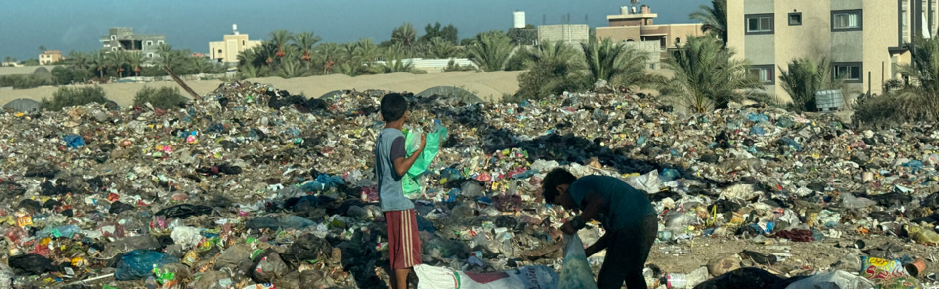 Children in Gaza searching through scattered waste. Photo by OHCHR/Olga Cherevko