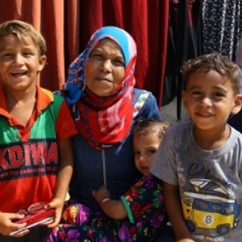 Miassar Zo’orb with family members, in front of their home. Photo by Secours Islamique France  